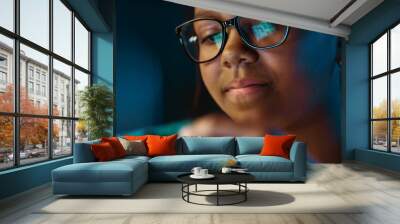 Close Up Portrait of a Cute Young Teenage Multiethnic Black Girl is Studying a Small Printed Circuit Board Object. Young Female Wears Glasses and Works on Her School Science Project. Wall mural