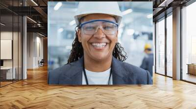 Close Up Portrait of a Happy and Smiling Middle Aged African Female Engineer in White Hard Hat Standing at Electronics Manufacturing Factory. Black Heavy Industry Specialist Posing for Camera. Wall mural