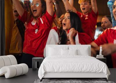 Close Up Portraits of a Diverse Group of Supportive Soccer Fans with Painted Faces Standing in a Bar, Cheering for Their Team. Raising Hands and Shouting. Friends Celebrate Victory After the Goal. Wall mural