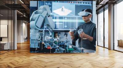 Computer Science Engineer in Virtual Reality Headset Using Controllers and Operating Robot Arm Under his Control. VFX Augmented Reality Icons Demonstrate Innovative Technologies Concept. Wall mural