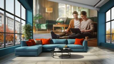 Couple Use Laptop Computer, while Sitting on the Living Floor room of their Apartment. Boyfriend and Girlfriend Talk, Shop on Internet, Choose Product to Order Online, Watch Streaming Service Wall mural