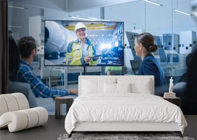 Diverse Group of Specialists, Managers in the Factory Office Meeting Room, Have Conference Video Call with Factory Chief Female Engineer, She Talks about Production Growth, Uses Tablet Computer Wall mural