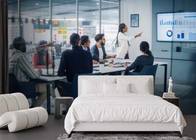 Diverse Modern Office: Black Businesswoman Leads Business Meeting with Managers, Talks, uses Presentation TV with Statistics, Graphs, Big Data. Digital Entrepreneurs Work on eCommerce Project Wall mural