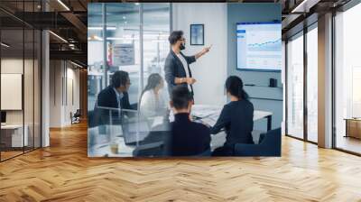 diverse modern office: motivated businessman leads business meeting with managers, talks, uses prese Wall mural