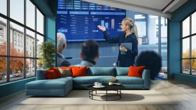 Diverse Modern Office: Successful Businesswoman Uses TV Screen with Big Data, Statistics, Talks about Company Growth, Discusses Strategy with Investors. Information Technology Expert Talks Wall mural