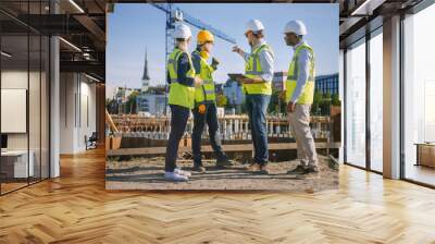 Diverse Team of Specialists Use Tablet Computer on Construction Site. Real Estate Building Project with Civil Engineer, Architect, Business Investor and General Worker Discussing Plan Details. Wall mural