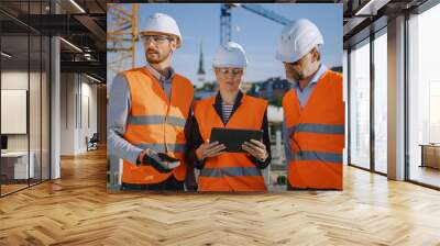 Diverse Team of Specialists Use Tablet Computer on Construction Site. Real Estate Building Project with Civil Engineer, Architect, Business Investor Discussing Planning and Development Details. Wall mural