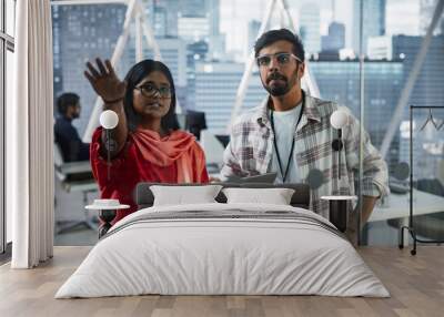 Female and Male Indian Financial Advisers Use Laptop Computer to Discuss a Stock Market Strategy in a Modern Company. South Asian Managers Collaborate on a Banking Research and Development Project Wall mural