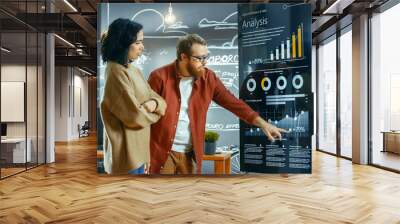 Female Developer and Male Statistician Use Interactive Whiteboard Presentation Touchscreen to Look at Charts, Graphs and Growth Statistics. They Work in the Stylish Creative Office. Wall mural