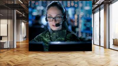 Female IT Engineer Works on Her Desktop Computer in Government Surveillance Agency. In the Background People at Their Workstations with Multiple Screens Showing Graphics. Wall mural