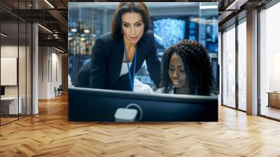 Female Team Leader Consults Young Computer Engineer. They Work in a Crowded Office on a Neural Network/ Artificial Intelligence Project. Wall mural