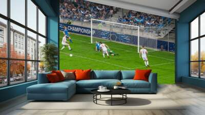 Football Championship Stadium with Crowd of Fans: Soccer Football Match Championship: Blue Team Players with Black Forward Leading Attack, Scores Goal. Sport Channel Broadcast TV Concept. Wall mural