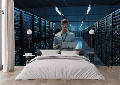 Futuristic Concept: Big Data Center Chief Technology Officer Using Laptop Standing In Warehouse, Information Digitalization Lines Streaming Through Servers. SAAS, Cloud Computing, Web Service Wall mural