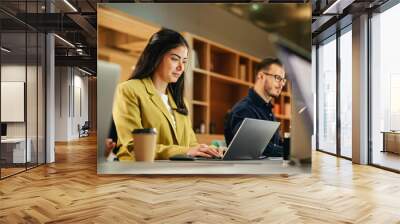 Group of Diverse Creative Team Members Using Laptops in an active Contemporary Office. Young Female Media Relations Manager Working on Brand Innovation Strategy and Collaborating with Colleagues. Wall mural