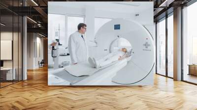 In Medical Laboratory Female Radiologist and Male Doctor Control and Monitor MRI or CT Scan with Female Patient Undergoing Procedure. High-Tech Modern Medical Equipment.  Wall mural