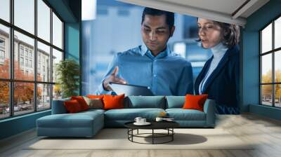 In Technology Research Facility: Female Project Manager Talks With Chief Engineer, they Consult Tablet Computer. Team of Industrial Engineers, Developers Work on Engine Design Using Computers Wall mural