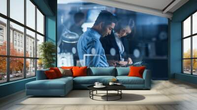 In Technology Research Facility: Female Project Manager Talks With Chief Engineer, they Consult Tablet Computer. Team of Industrial Engineers, Developers Work on Engine Design Using Computers Wall mural