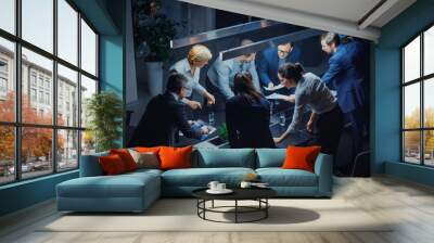 In the Dark Corporate Meeting Room Diverse Group of Executives, Business Associates and Investors Lean on a Conference Table During Emotional Discussion, Planning and Strategizing. High Angle Shot Wall mural