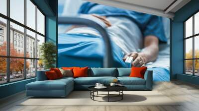 In the Hospital Sick Male Patient Sleeps on the Bed. Heart Rate Monitor Equipment is on His Finger. Wall mural