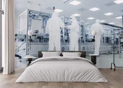 In the Manufacturing Facility Team of Scientist Wearing Sterile Protective Coverall Set's up / Programs Modern Industrial 3D Printer, High Precision Manufacture of Semiconductors under Process. Wall mural