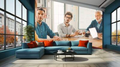 In the Meeting Room Young and Beautiful Female Junior Associate Makes a Speech / Report to a Board of Directors Member who are Sitting at the Conference Table. Modern Startup in the Stylish Office Wall mural