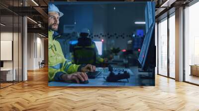 Industry 4.0 Modern Factory: Facility Operator Controls Workshop Production Line, Uses Computer with Screens Showing Complex UI of Machine Operation Processes, Controllers. Side View Shot. Wall mural