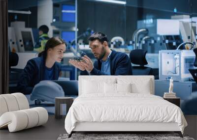 Industry 4.0 Modern Factory Meeting Room: Chief Engineer Holds Mechanism, Shows it to Female Designer, They Talk. Scientists in Contemporary Lab Build Electronic Machinery for With Futuristic Design Wall mural