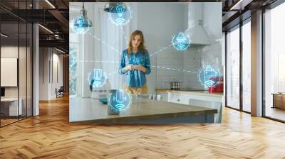 Internet of Things Concept: Young Woman Using Smartphone in Kitchen. She controls her Kitchen Appliances with IOT. Graphics Showing Digitalization Visualization of Connected Home Electronics Devices Wall mural