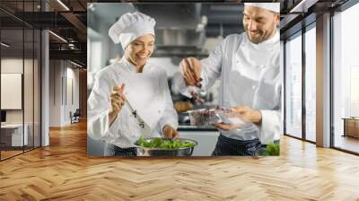 Male and Female Famous Chefs Team Prepare Salad for Their Five Star Restaurant. They Work on a Big Restaurant Stainless Steel Professional Kitchen. Wall mural