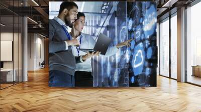 male it specialist holds laptop and discusses work with female server technician. they're standing i Wall mural