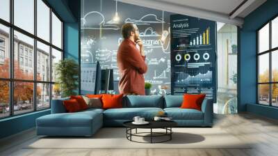 Marketer Looks at Interactive Touchscreen Whiteboard Showing Latest Graphs and Charts on Statistical Growth. He Works in the Creative Office. Wall mural