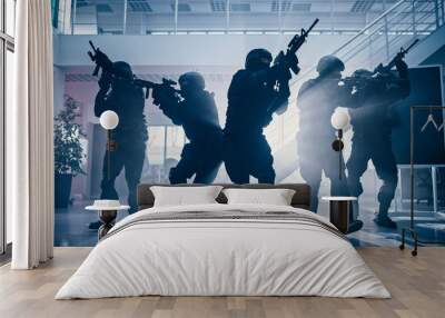 masked fireteam of armed swat police officers storm a bright seized office building with desks and c Wall mural