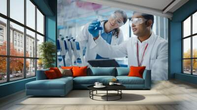 Modern Medical Research Laboratory: Two Scientists Working Together Analysing Chemicals in Laboratory Flask, Discussing Problem. Advanced Scientific Lab for Medicine, Biotechnology, Molecular Biology  Wall mural