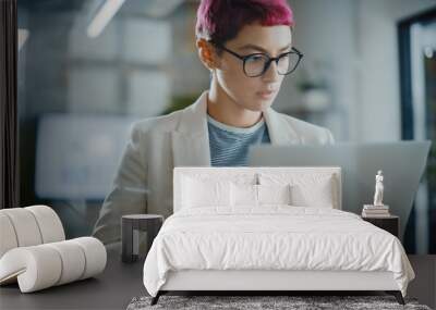 Modern Office: Portrait of Beautiful Creative Specialist with Short Pink Hair Standing, Holding Laptop Computer. Working on App Design, Data Analysis, Plan Strategy for Social Media Disruption Wall mural