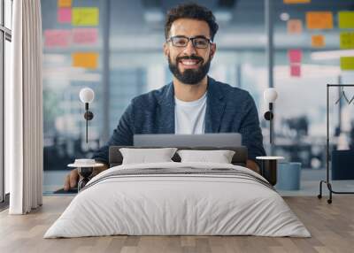 Modern Office: Portrait of Stylish Hispanic Businessman Works on Laptop, Does Data Analysis and Creative Designer, Looks at Camera and Smiles. Digital Entrepreneur Works on e-Commerce Startup Project Wall mural