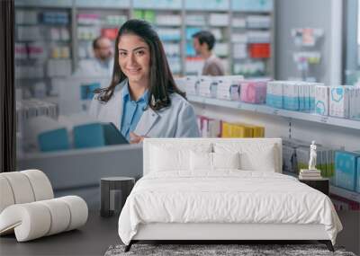 Pharmacy Drugstore: Portrait Shot of Beautiful Latina Pharmacist Wearing White Coat, Standing Among Shelfs with Health Care Products and Looks at the Camera, Smiles Charmingly. Professional Pharmacist Wall mural