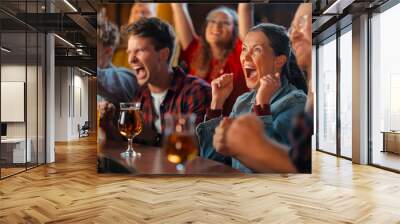 Portrait of a Beautiful Female Sitting at a Pub Counter with Group of Diverse Friends, Watching and Cheering for a Live Soccer Match. Supportive Fans Cheering, Applauding, Shouting and Drinking Beer. Wall mural