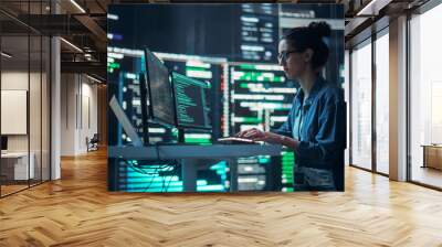 Portrait of a Woman Working on Computer, Typing Lines of Code that Appear on Big Screens Surrounding her in a Monitoring Room. Female Programmer Creating Innovative Software Using AI Data and System Wall mural