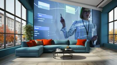 Portrait of a Young Female Professor Explaining Big Data and Artificial Intelligence Research Project in a Dark Room with a Screen Showing a Neural Network Model. Computer Science Education in College Wall mural