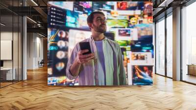 Portrait of Caucasian Man Using Smartphone in Metaverse With Animated Stream Of Interfaces With Social Media, e-Commerce Shopping, Internet Influencers And Games. Visualization Of Web Network. Wall mural