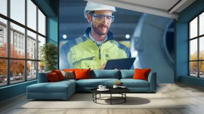 Portrait of Professional Heavy Industry Engineer / Worker Wearing Safety Uniform and Hard Hat Uses Tablet Computer. In the Background Construction Factory for Oil, Gas and Fuels Transport Pipeline Wall mural