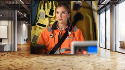 Portrait Shot of Professional Female EMS Paramedic Prepairing while Riding in an Ambulance Vehicle for an Emergency. Emergency Medical Technicians are on Their Way to a Call Outside the Hospital. Wall mural