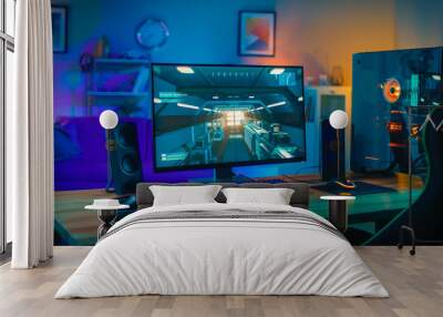 Powerful Personal Computer Gamer Rig with First-Person Shooter Game on Screen. Monitor Stands on the Table at Home. Cozy Room with Modern Design is Lit with Warm and Neon Light. Wall mural