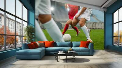 Professional Soccer Player Leads with a Ball, Masterfully Dribbling and Bypassing Sliding Tackles of His Opponents. Two Professional Football Teams Playing. Low Angle Shot. Wall mural