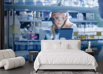 Research Female Scientist is using a Microscope and a Tablet Computer while Working in a Modern Laboratory. Doing Genetic and Pharmaceutical Researches. Wall mural