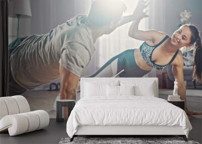 Smiling Strong and Beautiful Athletic Fitness Couple in Workout Clothes Doing Push Up Exercises and Giving Each Other a High Five in Their Bright and Spacious Living Room with Minimalistic Interior. Wall mural