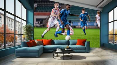 Soccer Football Match Event on a Major League Championship: Blue Team Attacks, Playing Pass, Dribbling. Game Tournament. Live Sport Channel Broadcast Television Concept. Wall mural