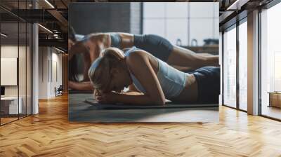 Strong Masculine Man and Two Fit Atletic Women Hold a Plank Position in Order to Exercise Their Core Strength. Blond Girl is Exhausted and is Struggling with Training. They Workout in a Loft Gym. Wall mural