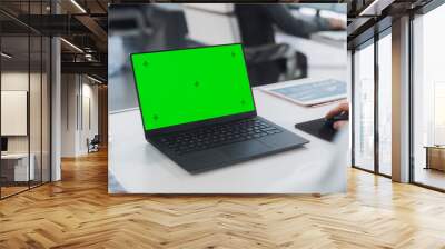 Successful Caucasian Businessman Sitting at Desk Working on Green Screen Laptop Computer in Office. Anonymous Businessperson using Chroma Key Display. Stylish Bright Workplace. Over Shoulder Close Up. Wall mural