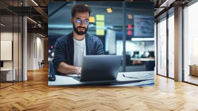 Successful Handsome Creative Director Working on Laptop Computer in Big City Office Late in the Evening. Businessman Preparing for a Marketing Plan in Conference Room. Wall mural